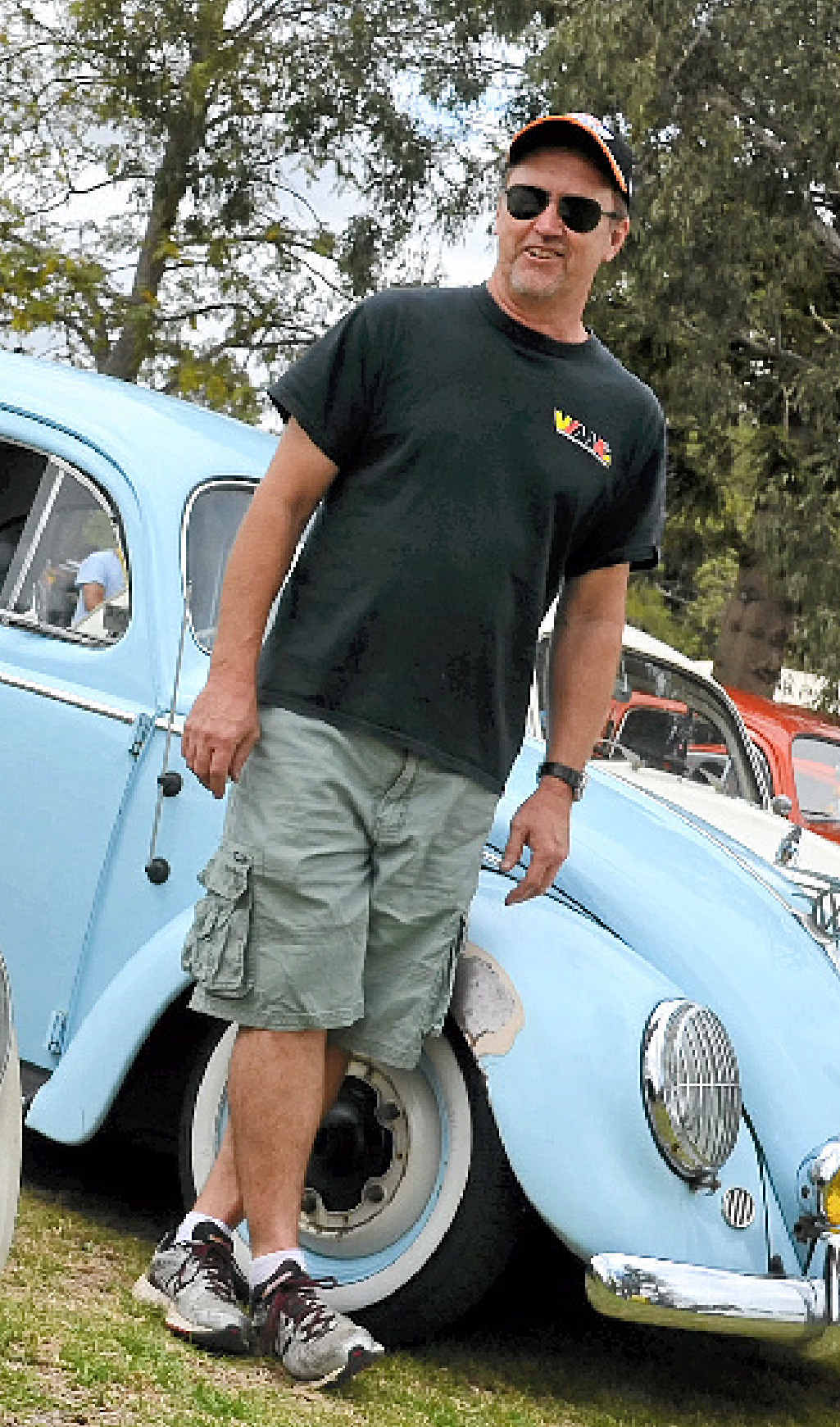 BATTLE OF THE BEETLES: VW Magazine Australia’s Craig Hughes with a selection of Volkswagen Beetles on display in Leslie Park on Saturday.